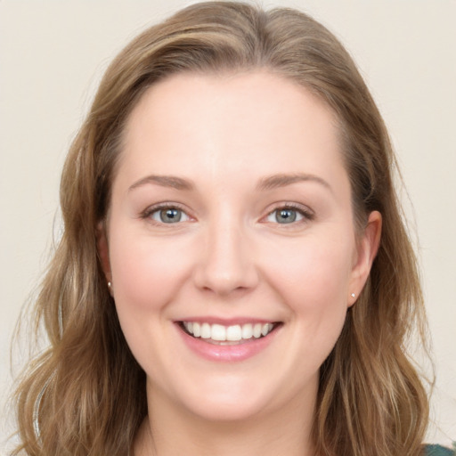 Joyful white young-adult female with long  brown hair and blue eyes