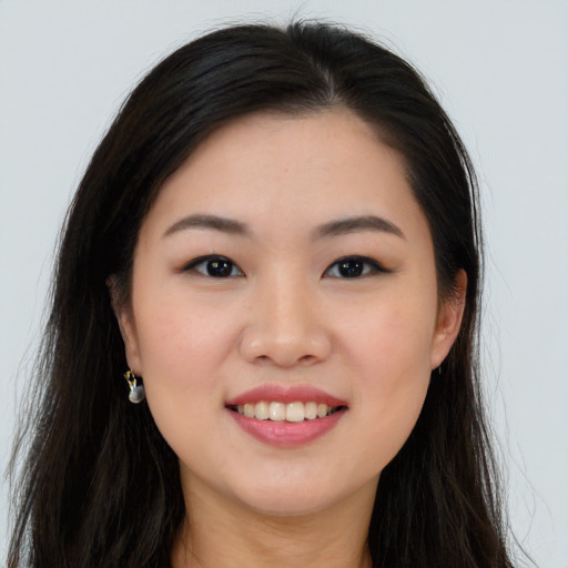 Joyful asian young-adult female with long  brown hair and brown eyes