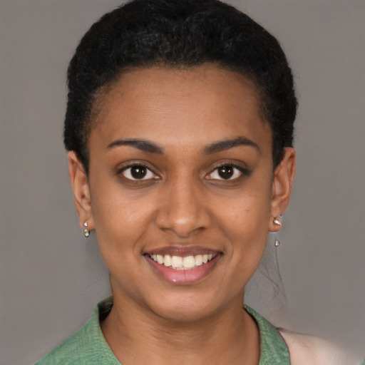 Joyful latino young-adult female with short  black hair and brown eyes