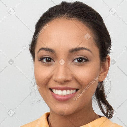 Joyful latino young-adult female with long  brown hair and brown eyes