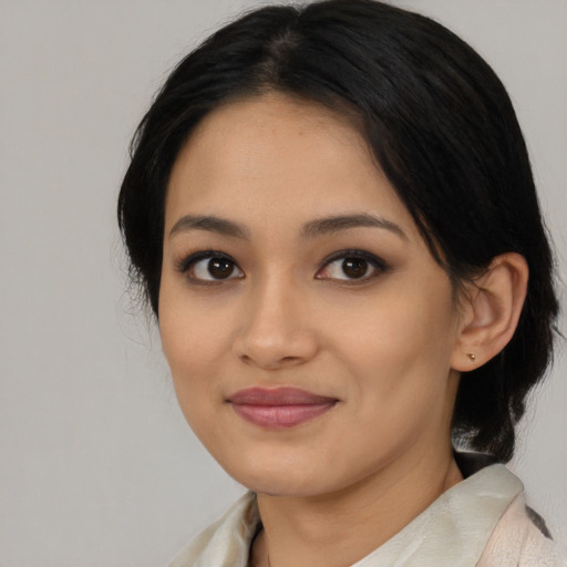 Joyful asian young-adult female with medium  black hair and brown eyes