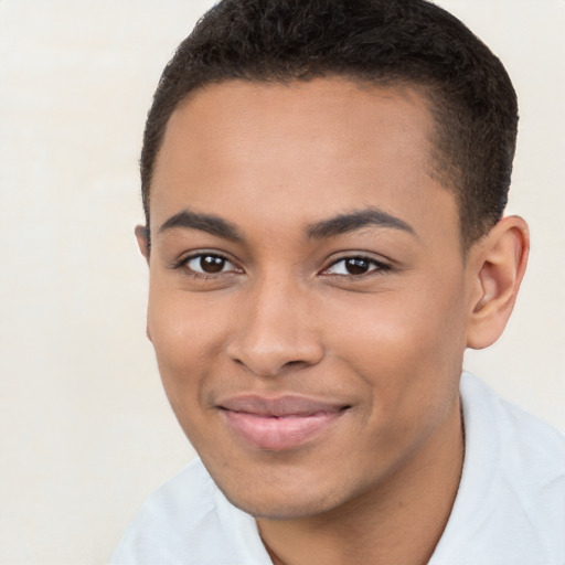 Joyful latino young-adult male with short  brown hair and brown eyes