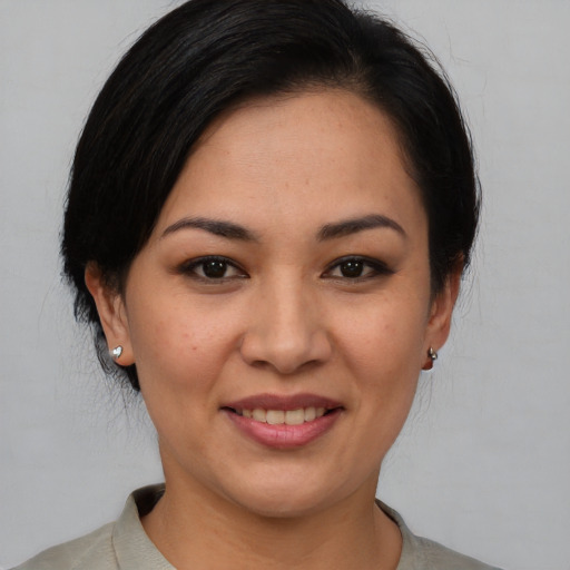 Joyful asian young-adult female with short  brown hair and brown eyes