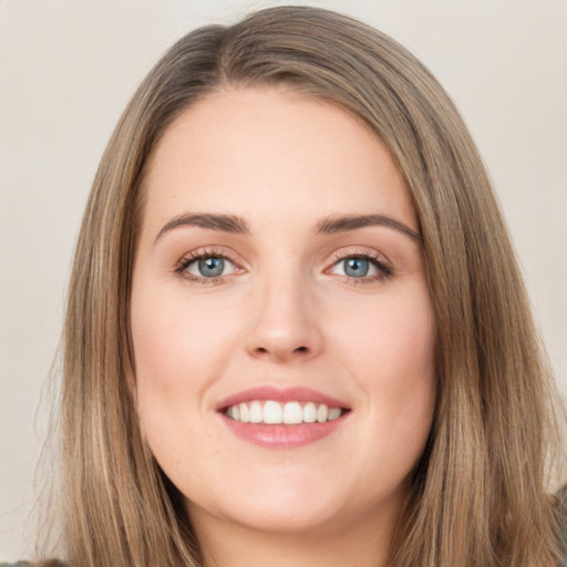 Joyful white young-adult female with long  brown hair and green eyes