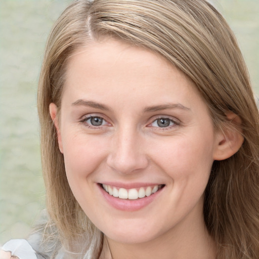 Joyful white young-adult female with long  brown hair and blue eyes