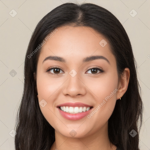 Joyful latino young-adult female with long  brown hair and brown eyes