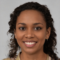 Joyful black young-adult female with medium  brown hair and brown eyes