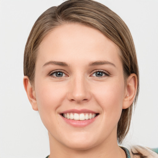 Joyful white young-adult female with medium  brown hair and grey eyes