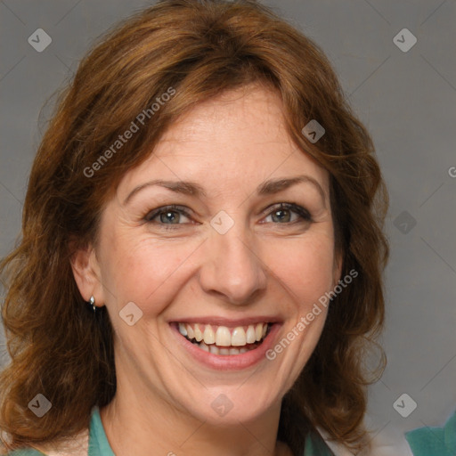 Joyful white adult female with medium  brown hair and green eyes