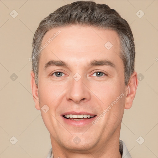 Joyful white adult male with short  brown hair and brown eyes