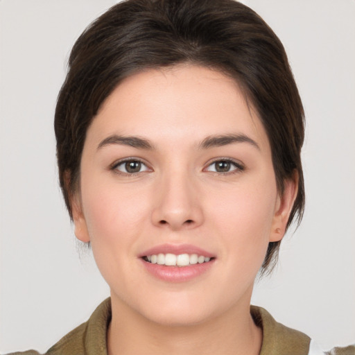 Joyful white young-adult female with medium  brown hair and brown eyes