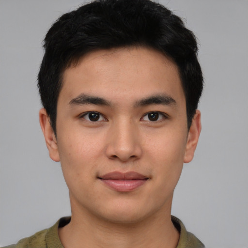 Joyful asian young-adult male with short  black hair and brown eyes