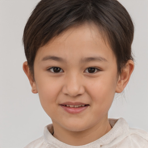 Joyful white child female with short  brown hair and brown eyes