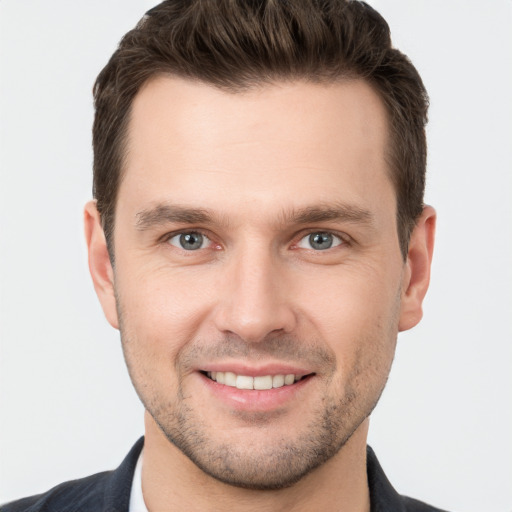 Joyful white young-adult male with short  brown hair and brown eyes