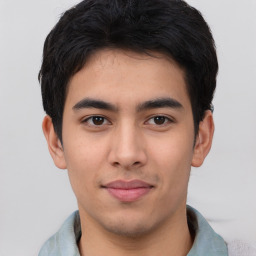 Joyful asian young-adult male with short  black hair and brown eyes