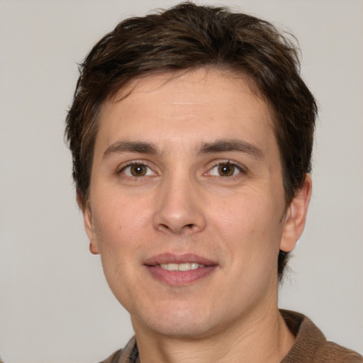 Joyful white adult male with short  brown hair and grey eyes