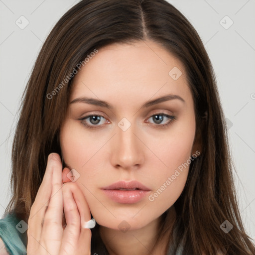 Neutral white young-adult female with long  brown hair and brown eyes