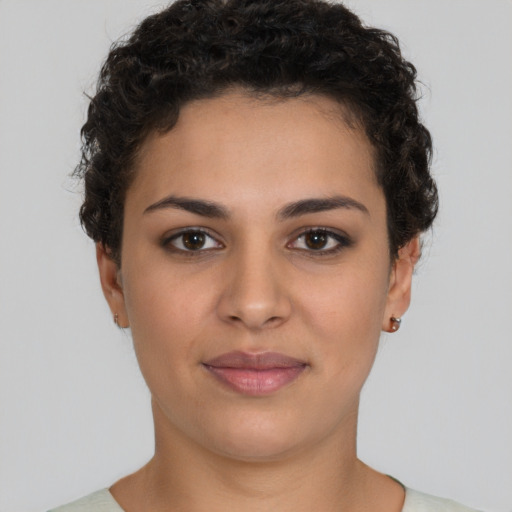 Joyful latino young-adult female with short  brown hair and brown eyes