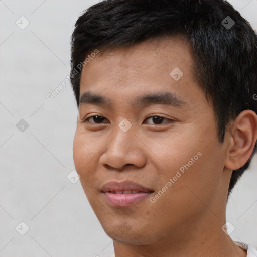 Joyful asian young-adult male with short  black hair and brown eyes