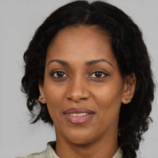 Joyful black adult female with medium  black hair and brown eyes