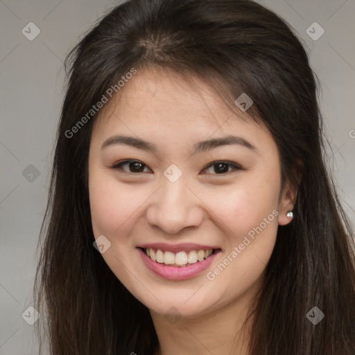 Joyful asian young-adult female with long  brown hair and brown eyes