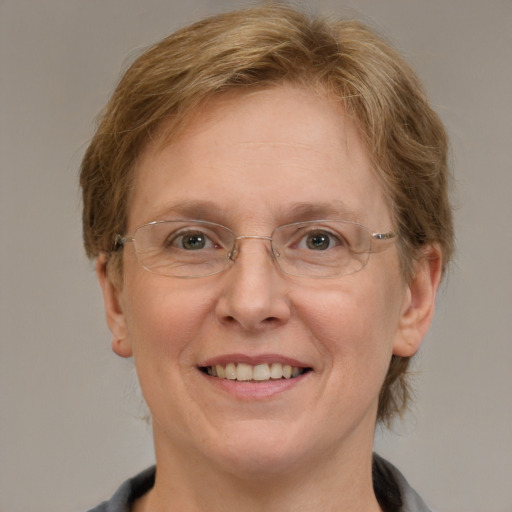 Joyful white adult female with medium  brown hair and blue eyes