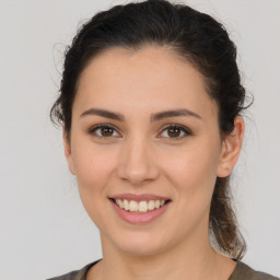 Joyful white young-adult female with medium  brown hair and brown eyes