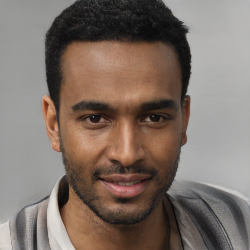 Joyful black young-adult male with short  black hair and brown eyes