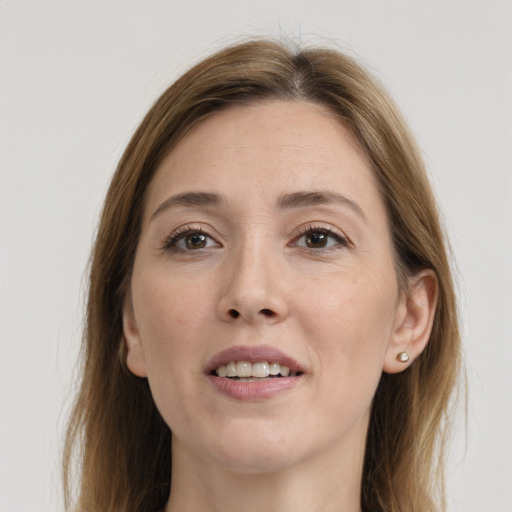 Joyful white young-adult female with long  brown hair and grey eyes