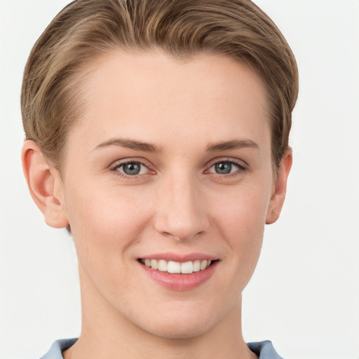 Joyful white young-adult female with short  brown hair and grey eyes