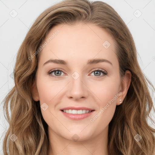 Joyful white young-adult female with long  brown hair and blue eyes