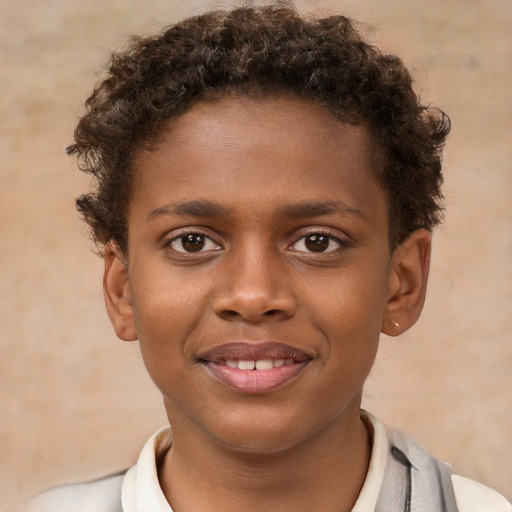 Joyful black child male with short  brown hair and brown eyes