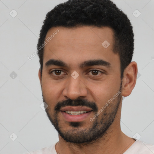 Joyful latino young-adult male with short  black hair and brown eyes