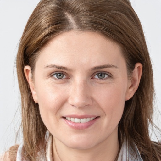 Joyful white young-adult female with long  brown hair and grey eyes