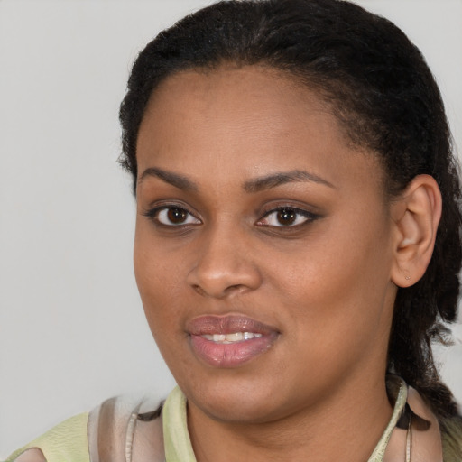 Joyful black young-adult female with medium  black hair and brown eyes