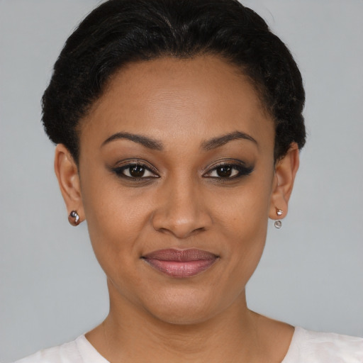 Joyful black young-adult female with short  brown hair and brown eyes
