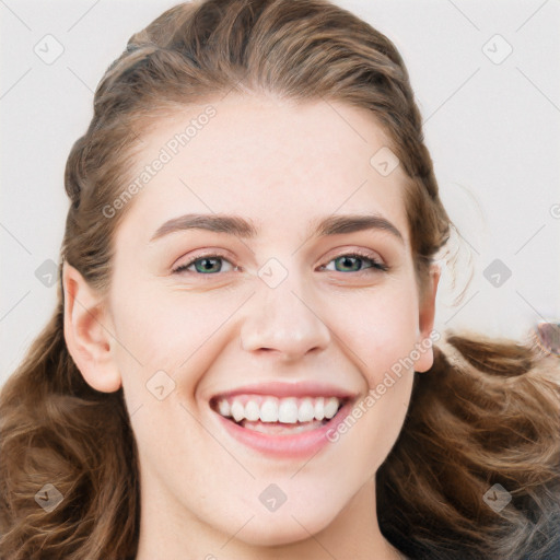 Joyful white young-adult female with long  brown hair and blue eyes