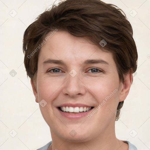 Joyful white young-adult female with short  brown hair and grey eyes