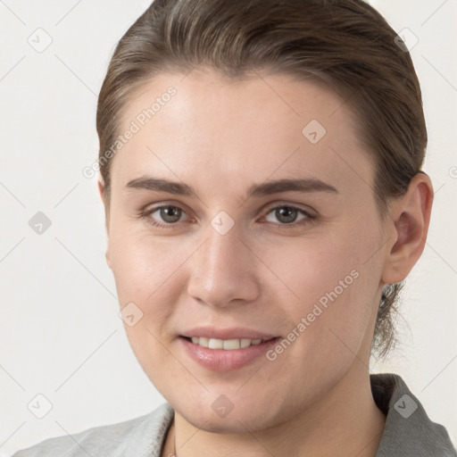 Joyful white young-adult female with short  brown hair and brown eyes