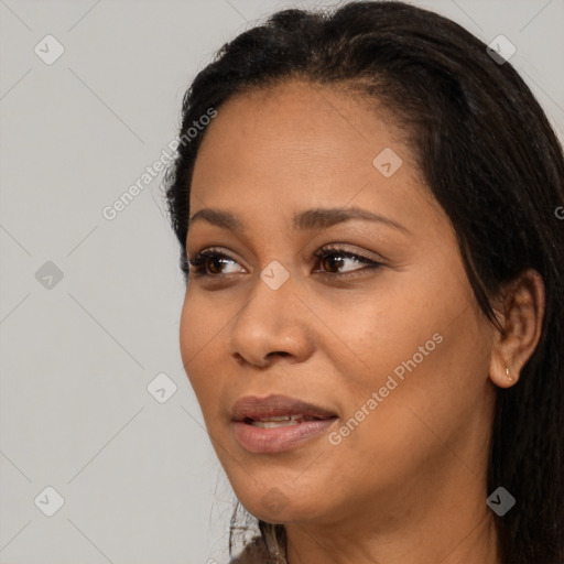 Joyful black adult female with long  black hair and brown eyes