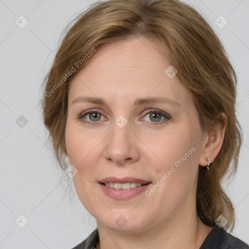 Joyful white adult female with medium  brown hair and grey eyes