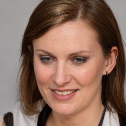 Joyful white adult female with medium  brown hair and brown eyes