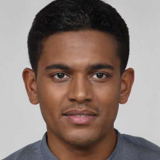 Joyful black young-adult male with short  brown hair and brown eyes