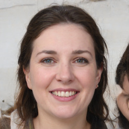 Joyful white young-adult female with medium  brown hair and grey eyes