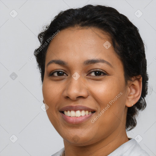 Joyful latino young-adult female with short  black hair and brown eyes