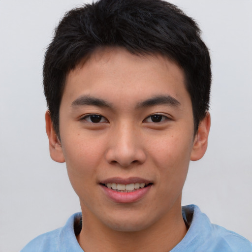 Joyful asian young-adult male with short  brown hair and brown eyes