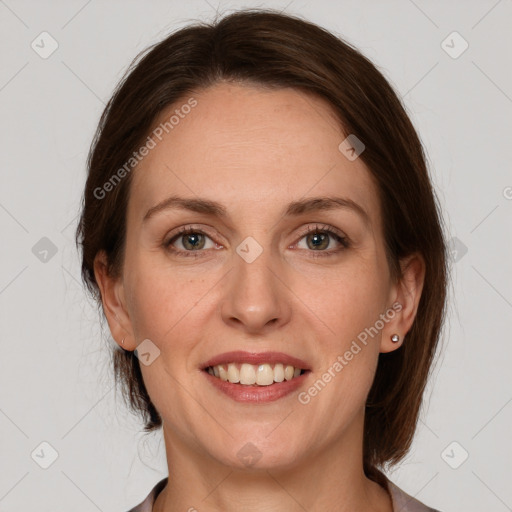 Joyful white adult female with medium  brown hair and grey eyes