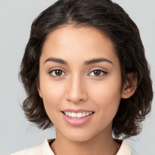 Joyful white young-adult female with medium  brown hair and brown eyes