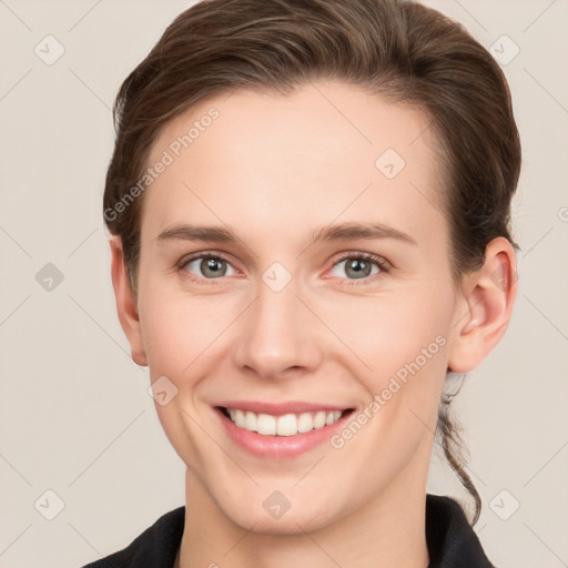 Joyful white young-adult female with short  brown hair and grey eyes