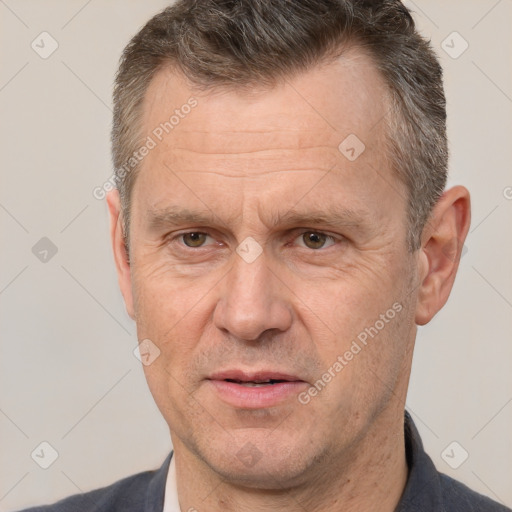 Joyful white middle-aged male with short  brown hair and brown eyes